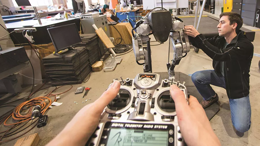 oregon state university students working with a robot