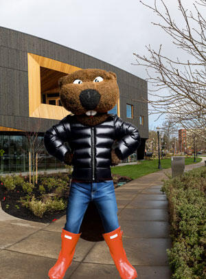 Benny standing outside on wet sidewalk in winter clothes