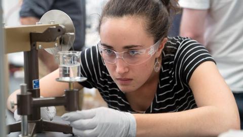 student working on science experiment