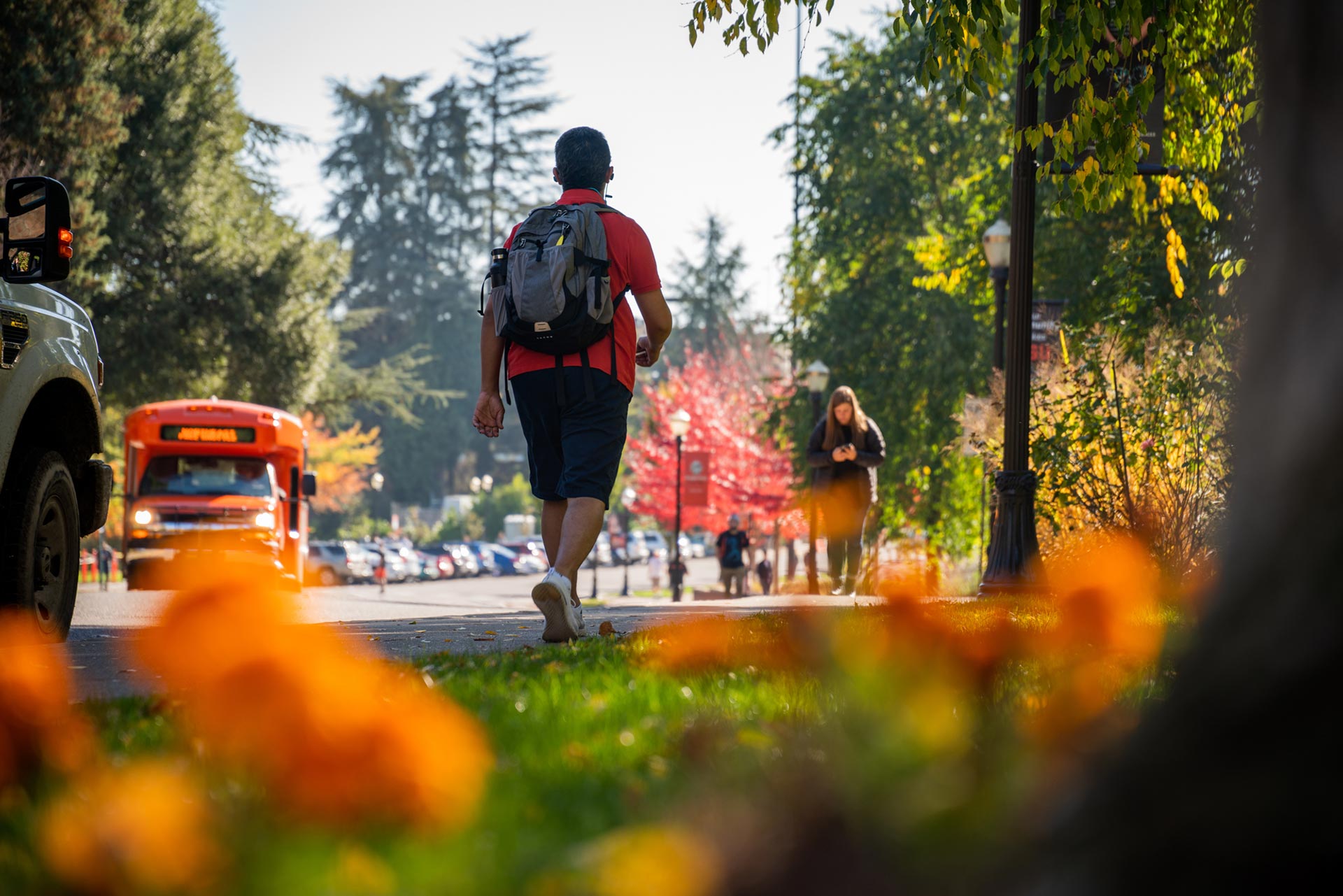 Student walking on campus during fall